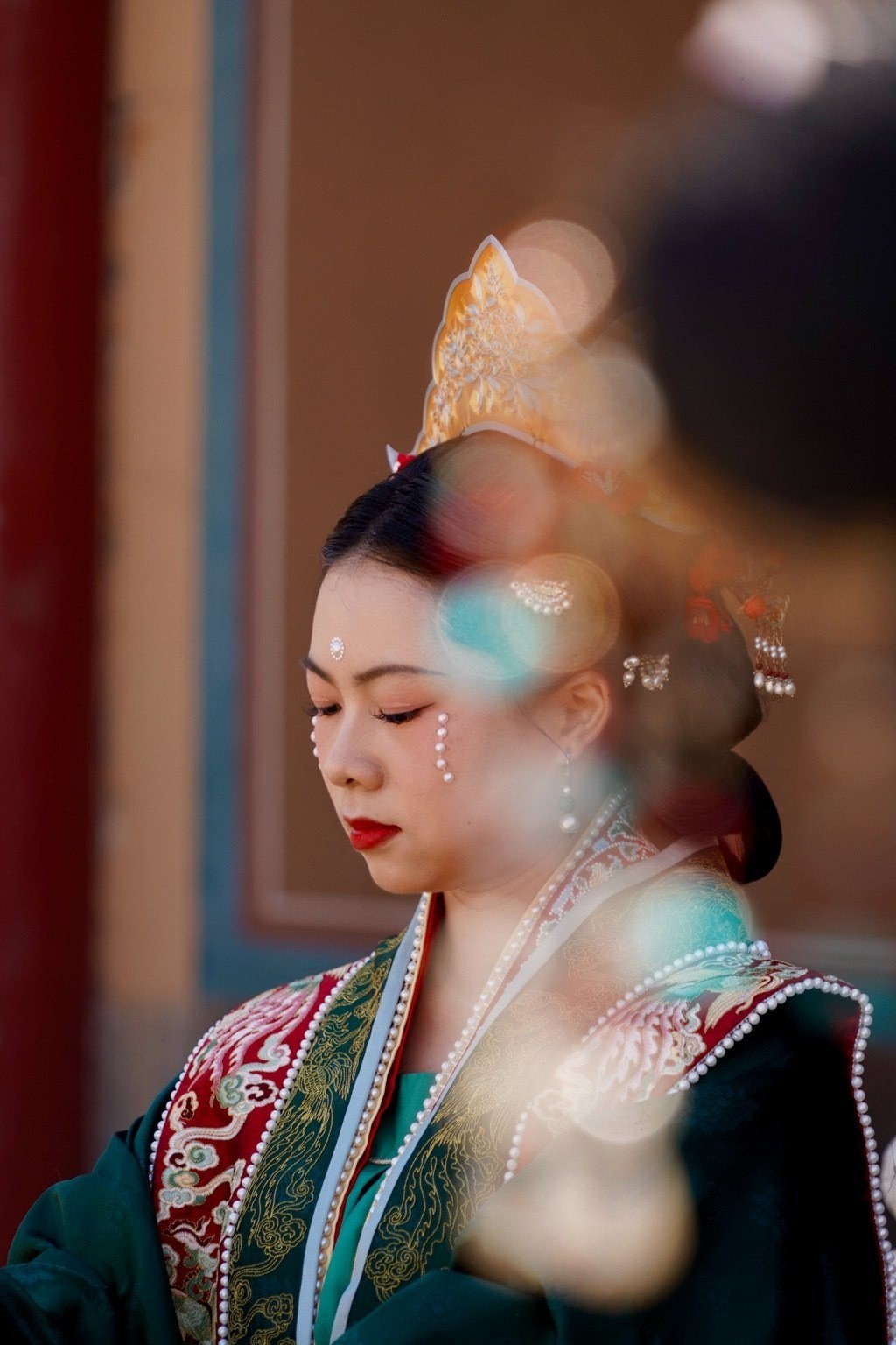 Woman in ceremonial dress illuminated by pearls of light in Beijing